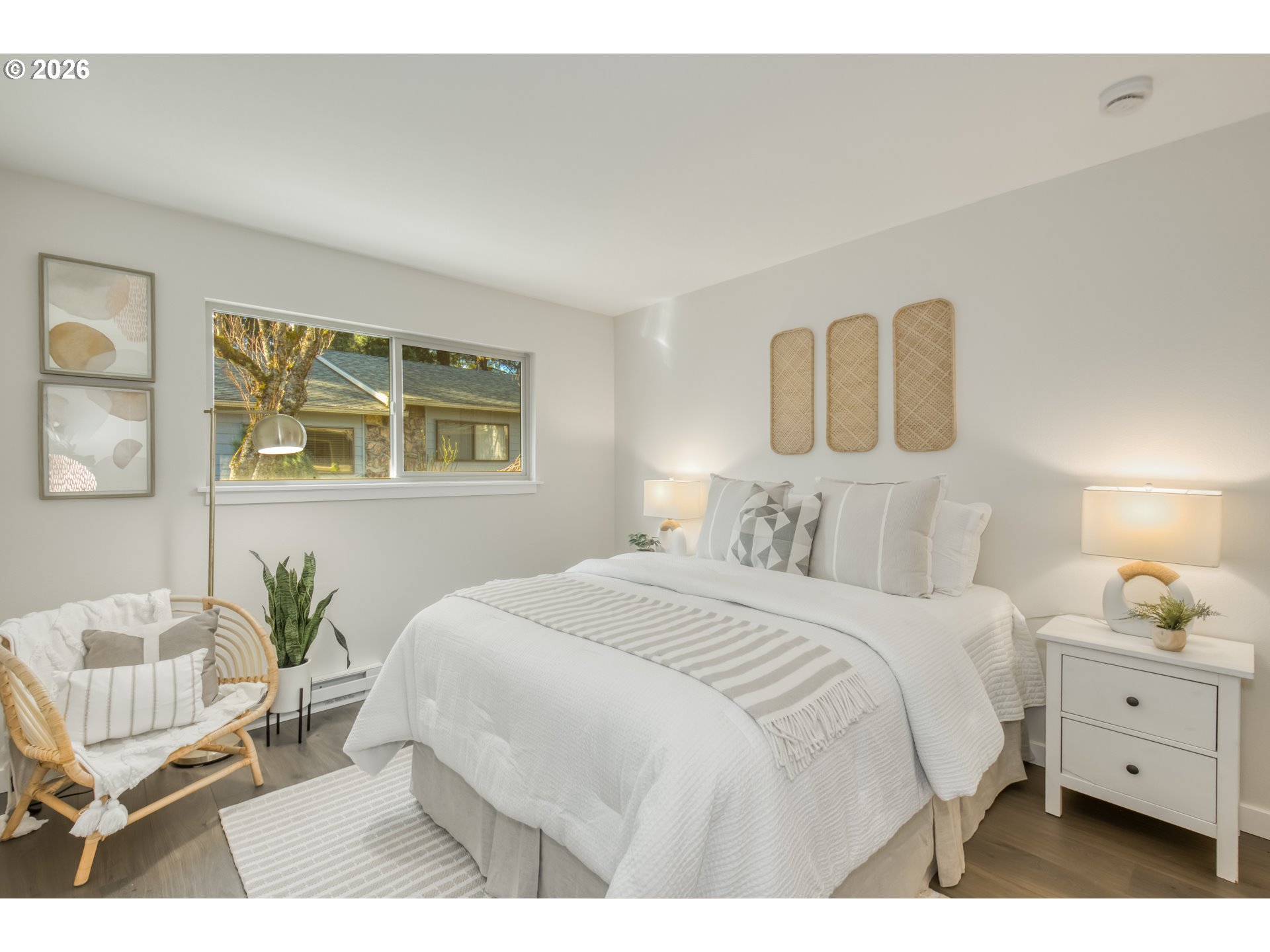 3114 Southwest Carson Street Portland, OR 97219 - Photo 17 of 18 a bedroom with a bed and wooden floor