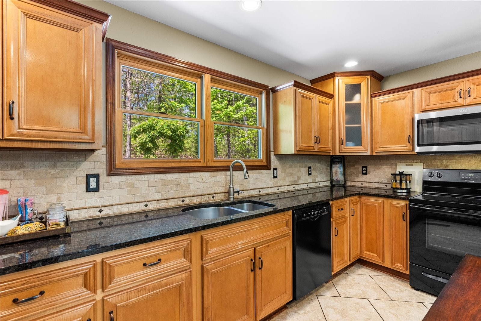 557 Green Forest Road Dunlap, TN 37327 - Photo 23 of 57 a kitchen with stainless steel appliances granite countertop a sink a stove and cabinets
