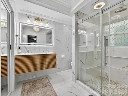 a bathroom with a shower and a mirror
