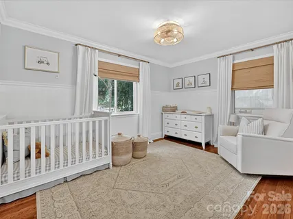 a spacious bedroom with a bed and a window