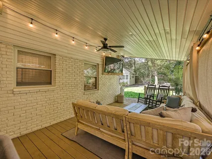 a view of a chair and tables in the balcony
