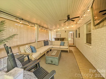 a balcony with furniture and a rug