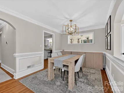 a view of a dining room with furniture and chandelier