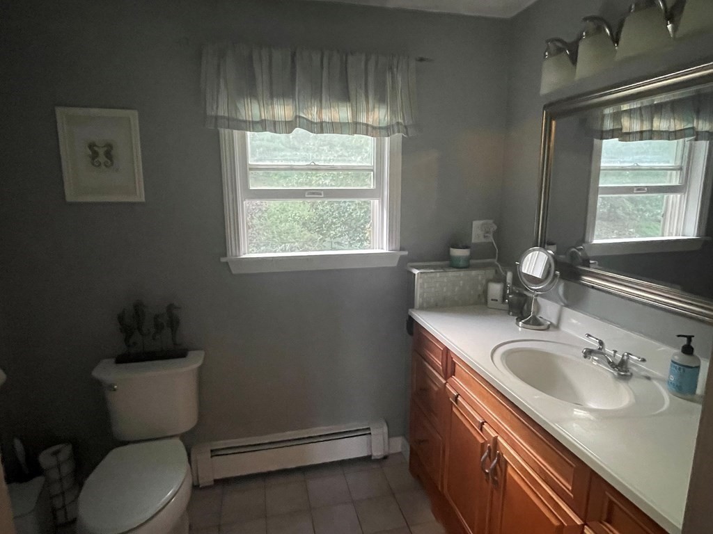 75 Blake Road Wrentham, MA 02093 - Photo 13 of 24 a bathroom with a sink toilet and window