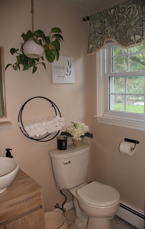 75 Blake Road Wrentham, MA 02093 - Photo 20 of 24 a bathroom with a toilet a sink and mirror