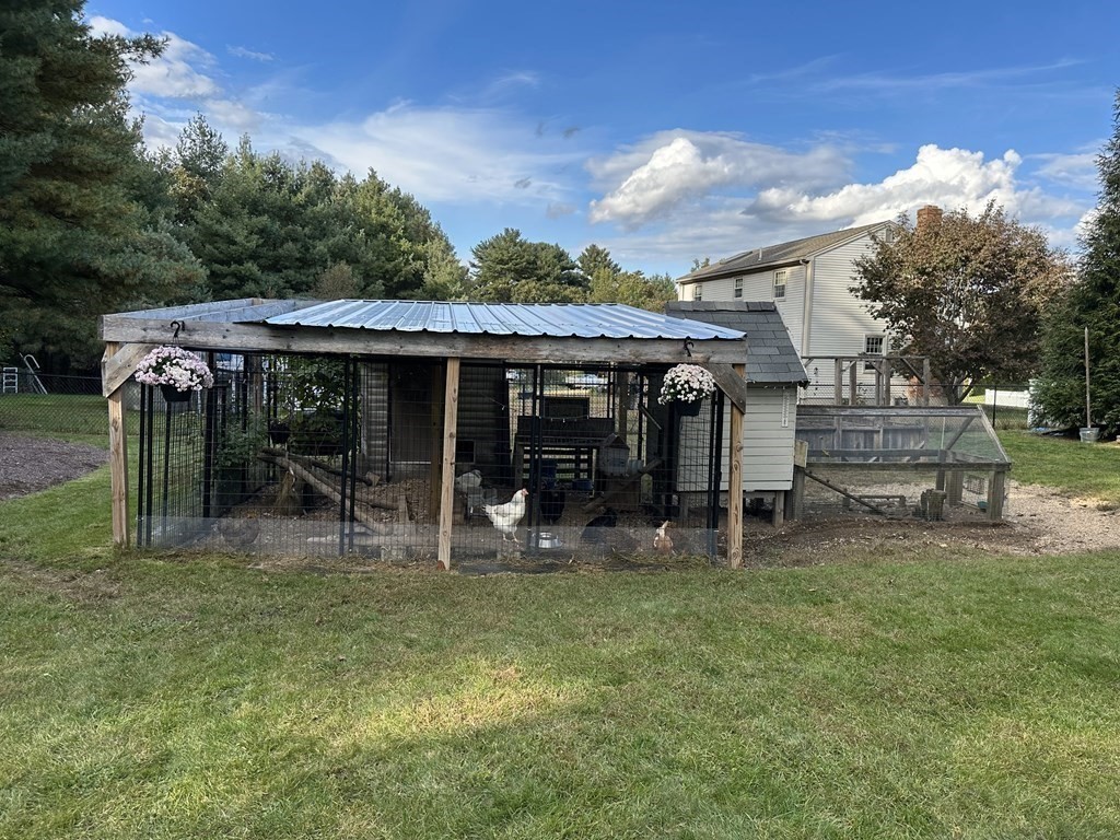 75 Blake Road Wrentham, MA 02093 - Photo 24 of 24 a patio with table and chairs under an umbrella