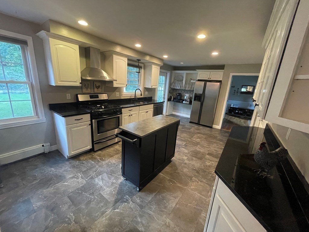 75 Blake Road Wrentham, MA 02093 - Photo 4 of 24 a kitchen with stainless steel appliances granite countertop a sink stove and refrigerator