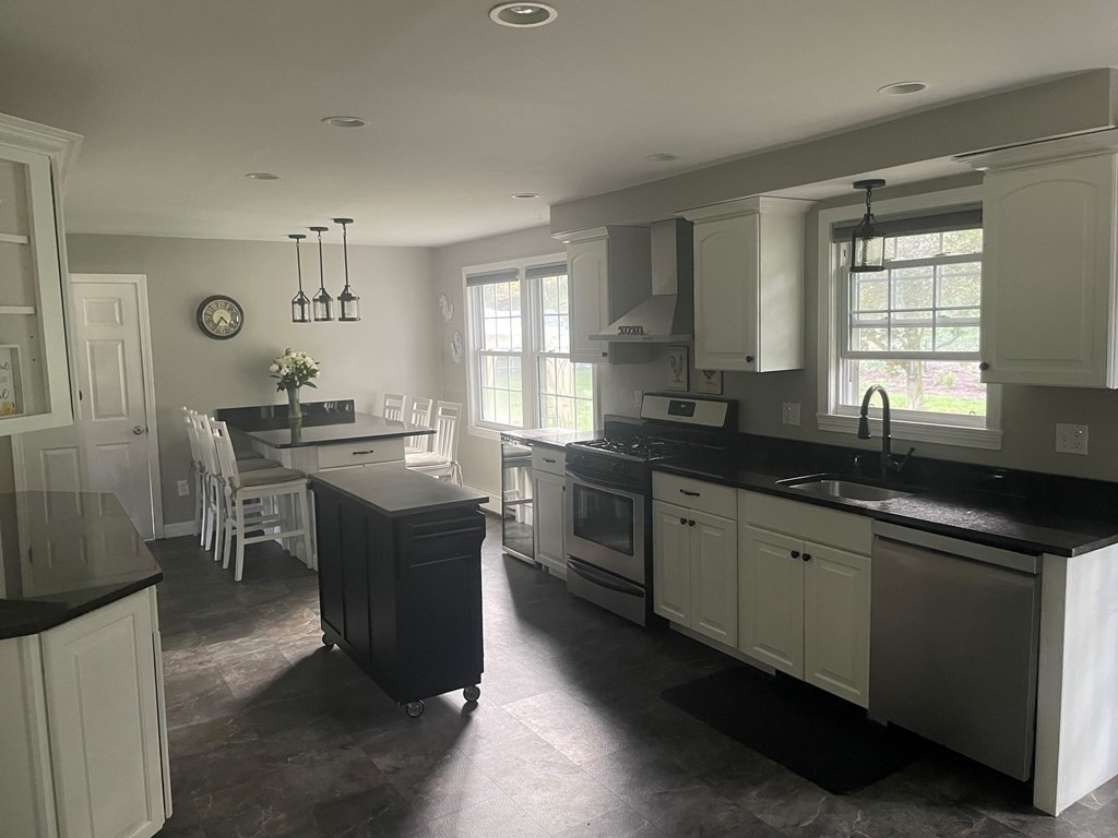 75 Blake Road Wrentham, MA 02093 - Photo 5 of 24 a kitchen with a sink stove and cabinets