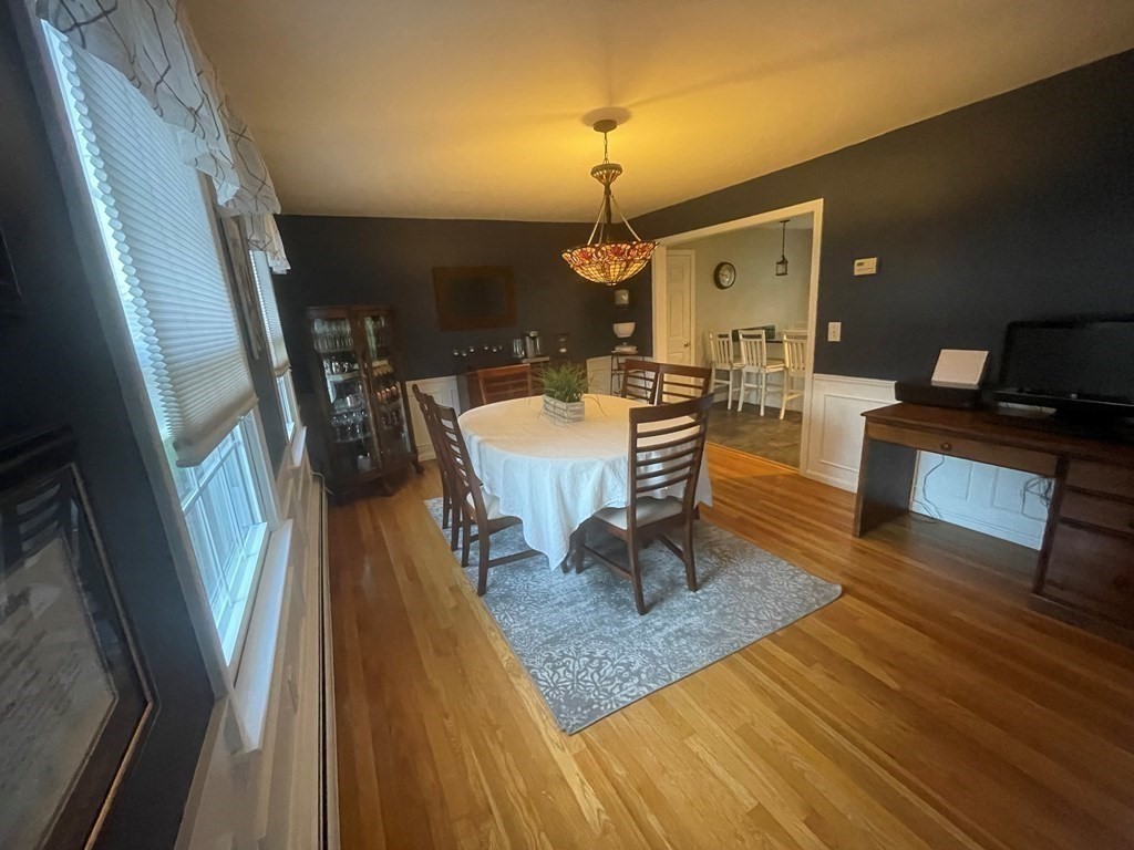 75 Blake Road Wrentham, MA 02093 - Photo 9 of 24 a living room with furniture and a chandelier