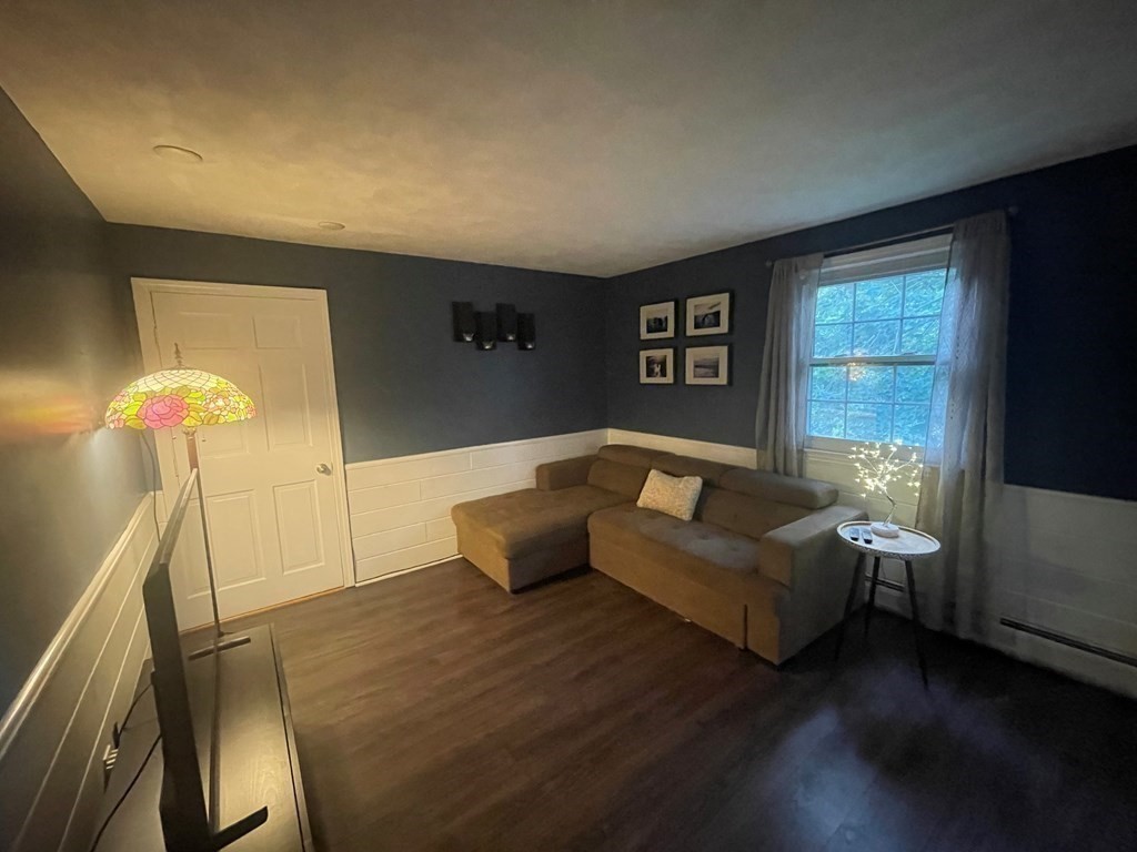 75 Blake Road Wrentham, MA 02093 - Photo 10 of 24 a living room with furniture and a flat screen tv