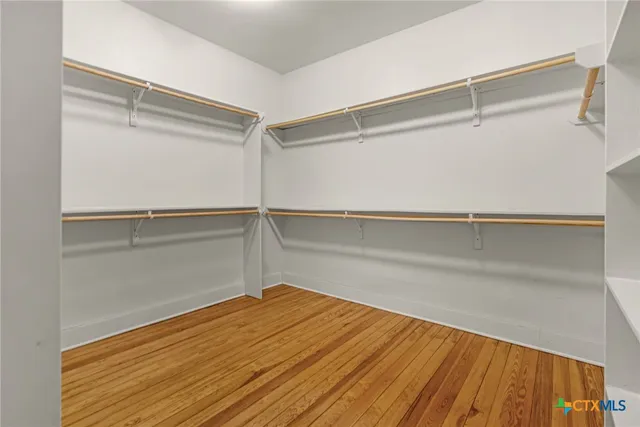 a view of a room with wooden floor