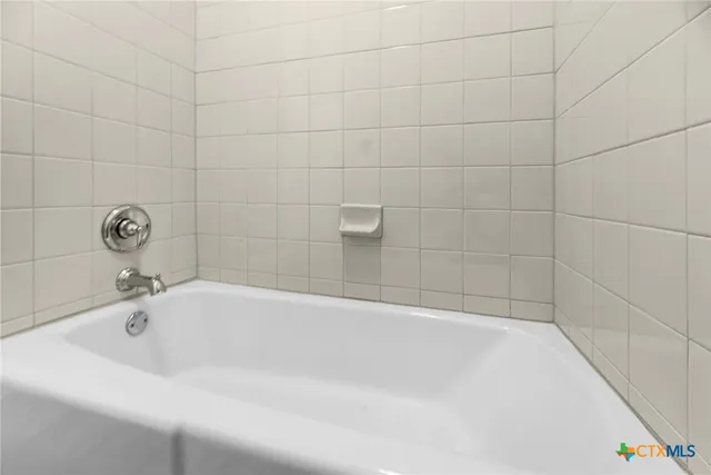 a white bath tub sitting in a bathroom