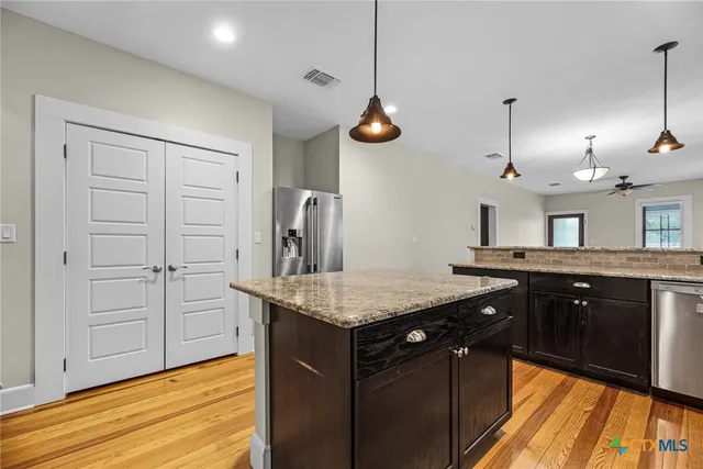 a kitchen with a counter space cabinets and appliances