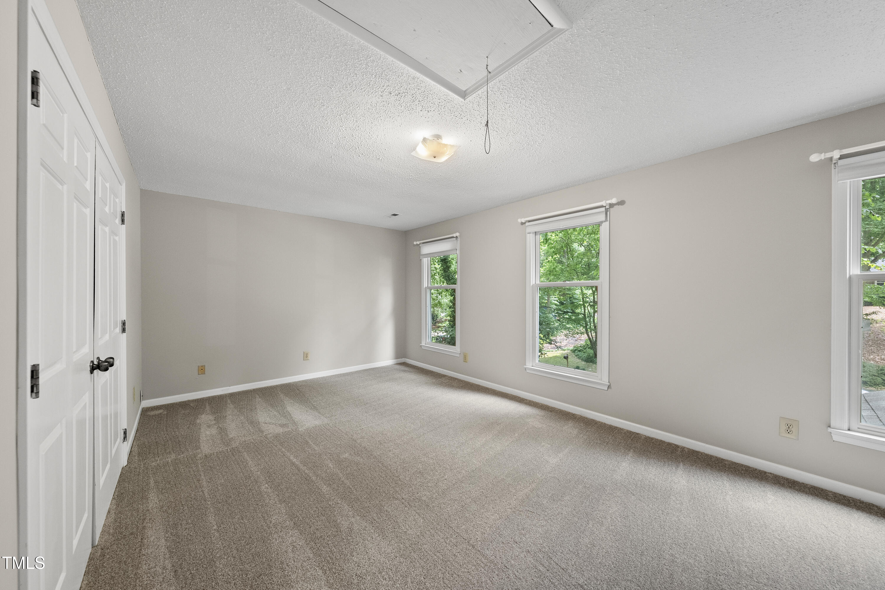 3517 Eden Croft Drive Raleigh, NC 27612 - Photo 14 of 22 a view of a big room with windows and chandelier fan