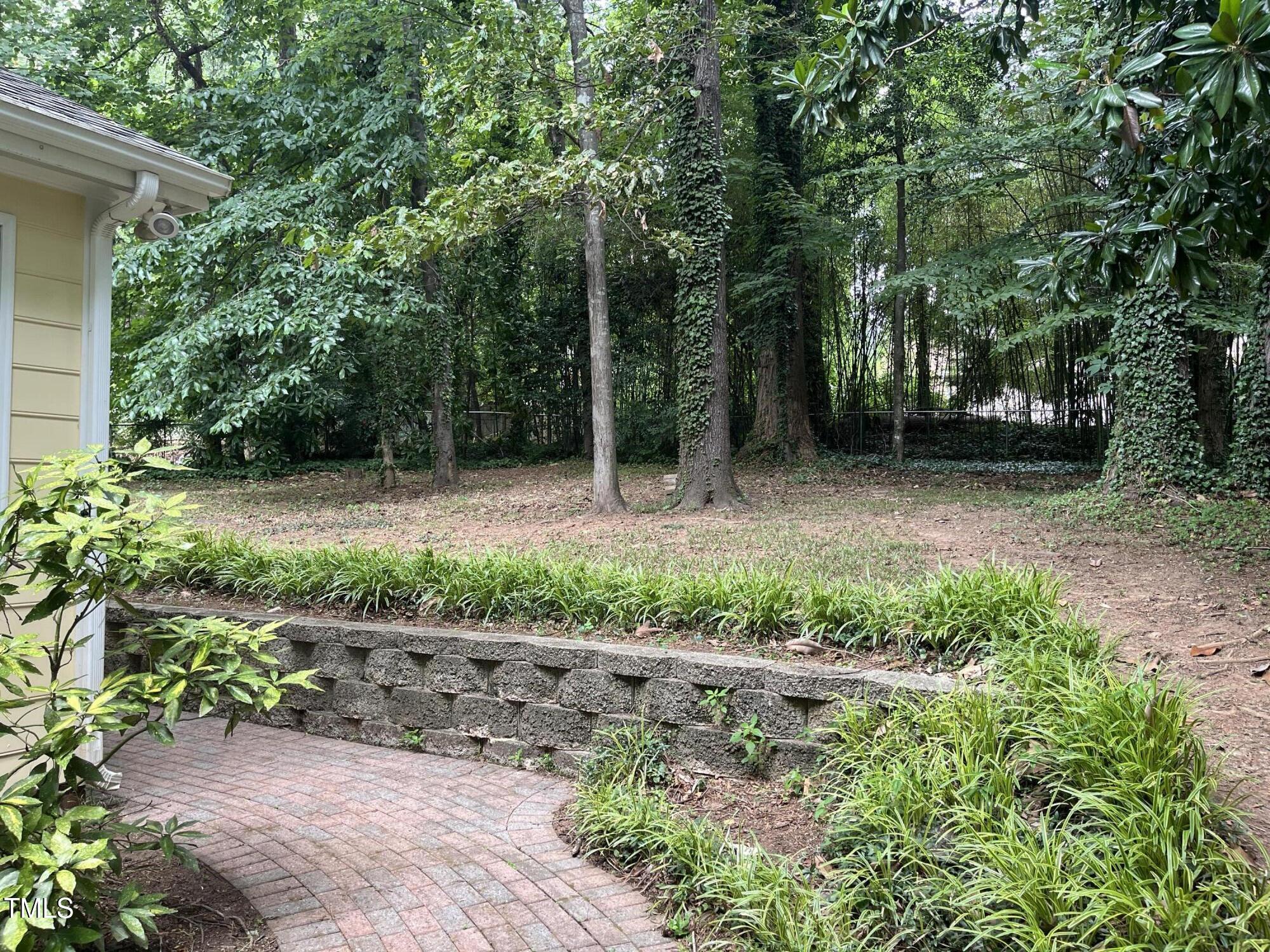 3517 Eden Croft Drive Raleigh, NC 27612 - Photo 21 of 22 a backyard of a house with lots of green space