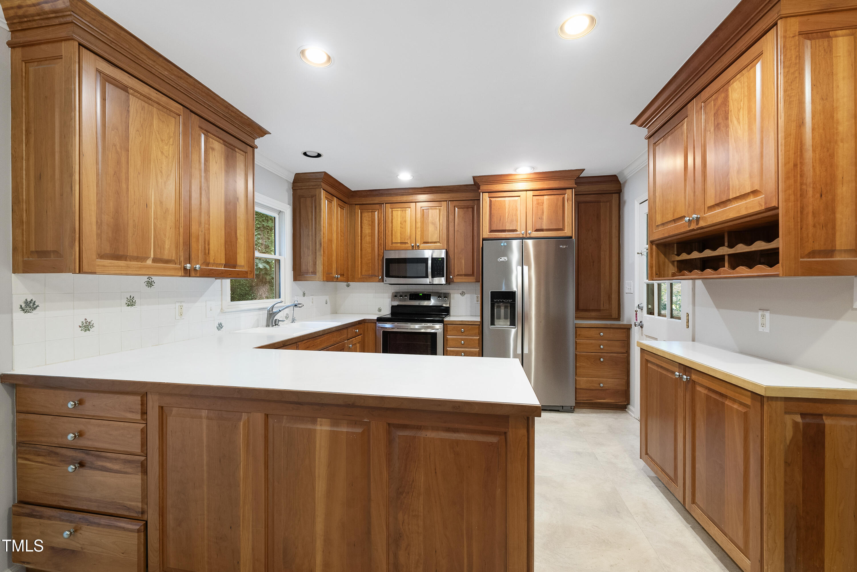 3517 Eden Croft Drive Raleigh, NC 27612 - Photo 5 of 22 a kitchen with stainless steel appliances a refrigerator sink and cabinets