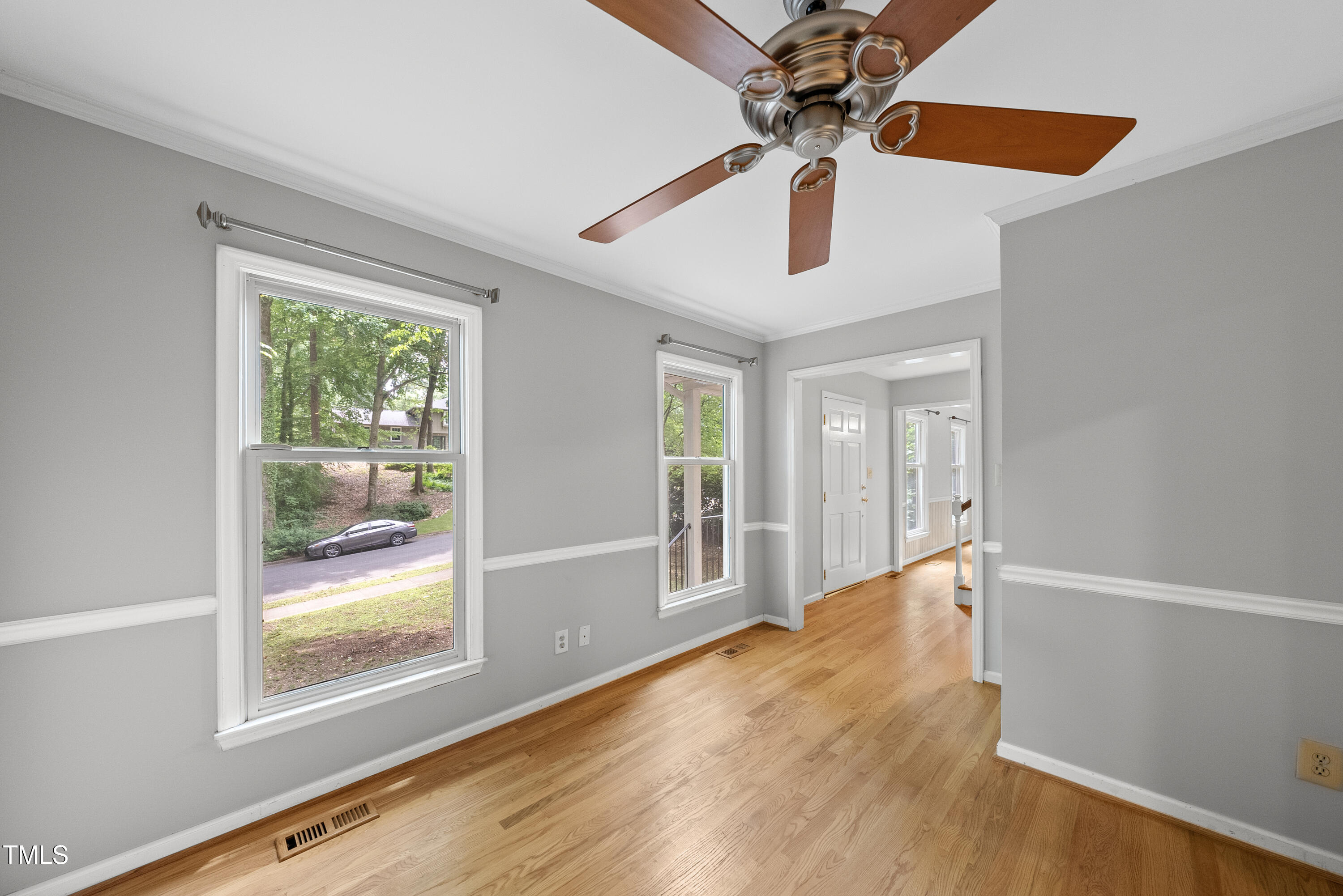 3517 Eden Croft Drive Raleigh, NC 27612 - Photo 9 of 22 a view of an empty room with window and wooden floor