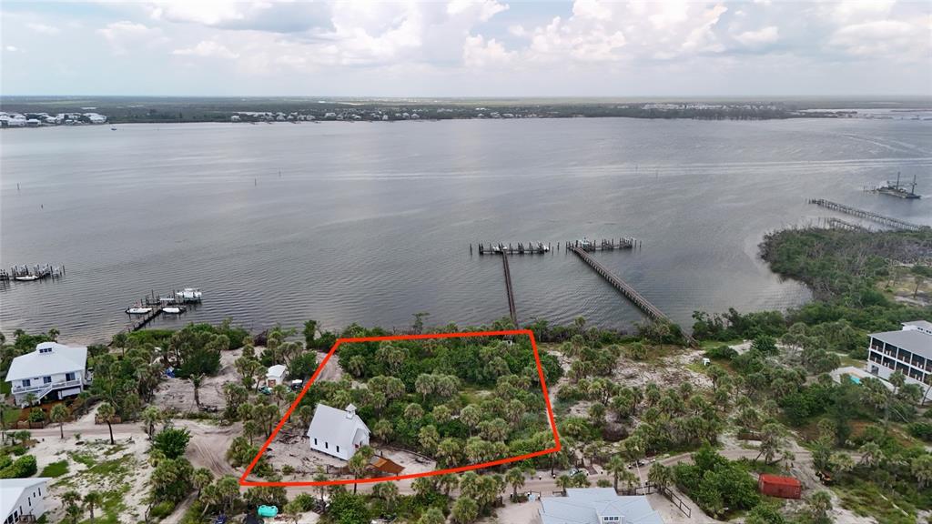 9144 Carter Street Placida, FL 33946 - Photo 18 of 19 a view of a lake with a bench and lake view