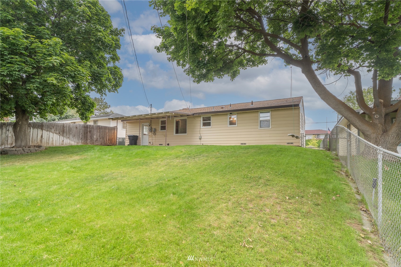 383 Maringo Road Ephrata, WA 98823 - Photo 24 of 29 a view of a house with a yard and a large tree