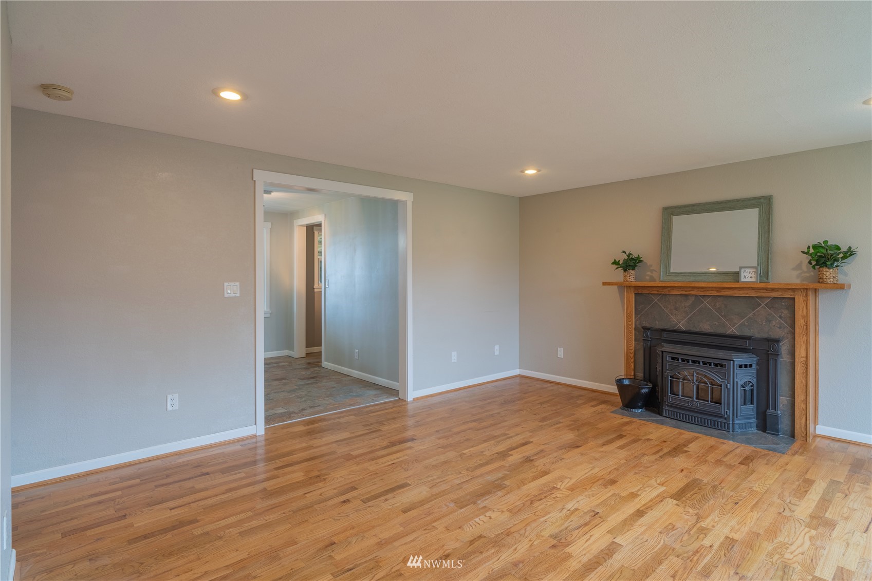 383 Maringo Road Ephrata, WA 98823 - Photo 4 of 29 a view of an empty room with wooden floor fireplace and a window