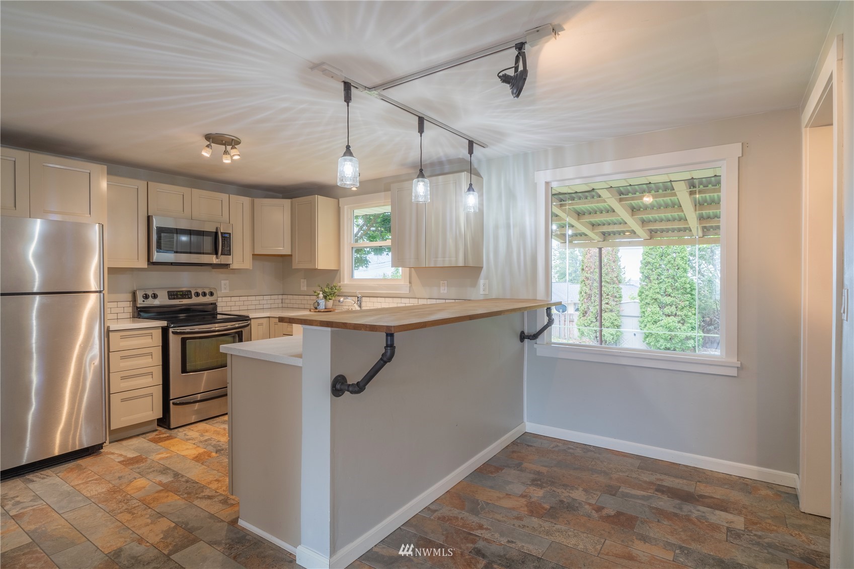 383 Maringo Road Ephrata, WA 98823 - Photo 8 of 29 a kitchen with kitchen island a counter top space a sink a refrigerator and a window