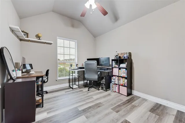 a view of a workspace with furniture and a window