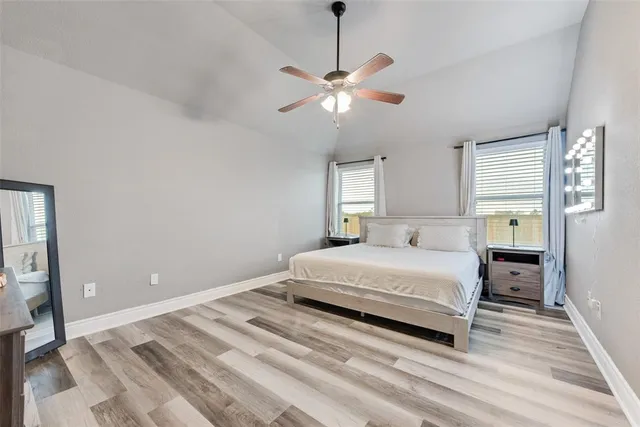 a spacious bedroom with a bed and window