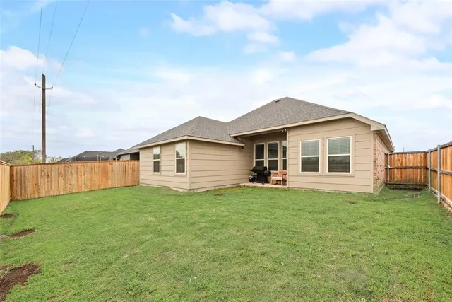 a view of a house with a yard and pathway