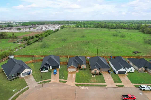 an aerial view of a house with garden space and street view
