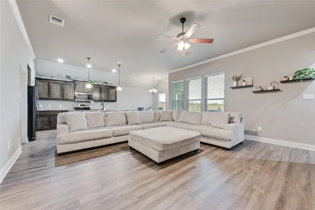 a living room with furniture and kitchen view