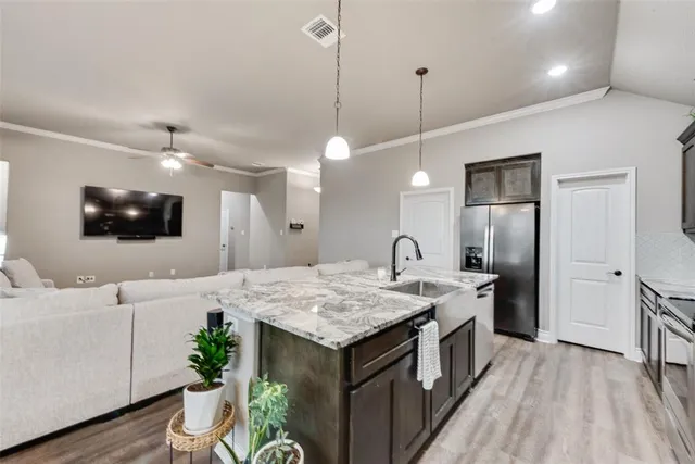 a kitchen with a stove and a wooden floor