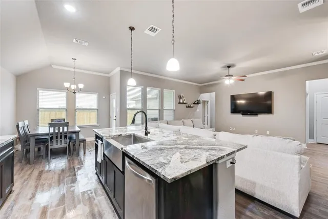a large kitchen with kitchen island a sink table and chairs