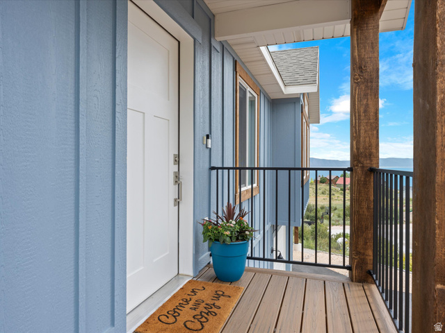 608 Fremont Road Fish Haven, ID 83287 - Photo 4 of 35 Covered entry deck with composite decking and black metal railing