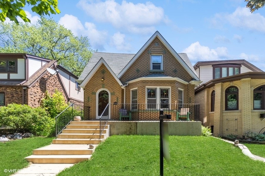 6129 North Mason Avenue Chicago, IL 60646 - Photo 1 of 22 a front view of a house with a yard
