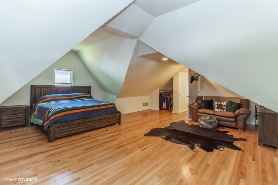 6129 North Mason Avenue Chicago, IL 60646 - Photo 11 of 22 a bedroom with a bed and wooden floor