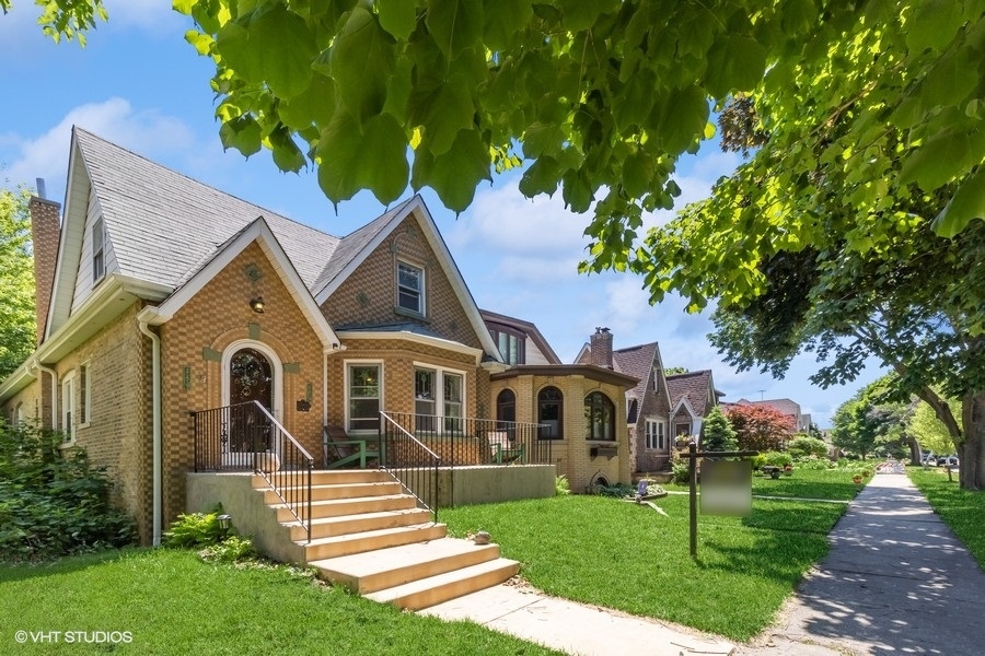 6129 North Mason Avenue Chicago, IL 60646 - Photo 2 of 22 a front view of a house with a yard