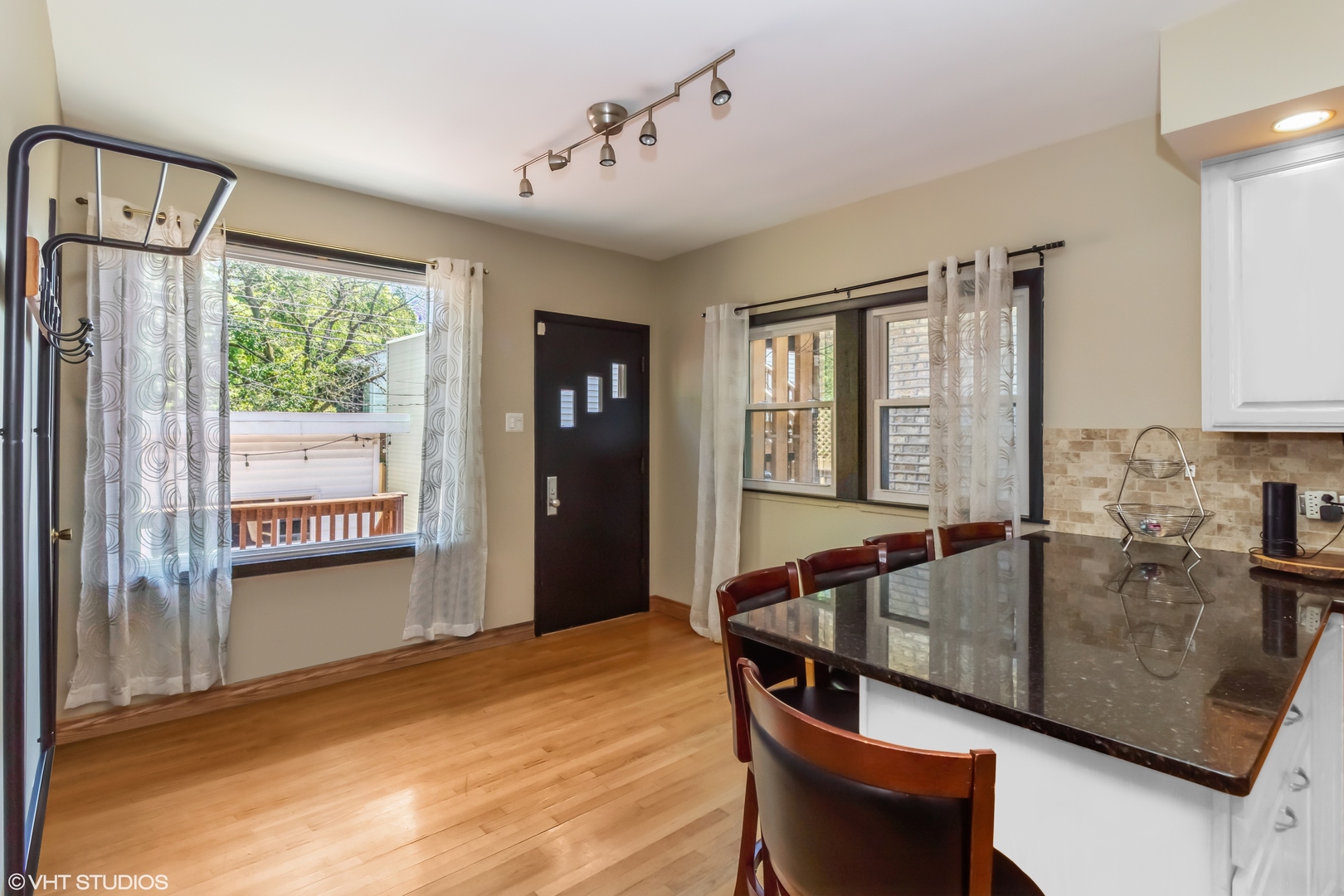 6129 North Mason Avenue Chicago, IL 60646 - Photo 6 of 22 a kitchen with granite countertop a sink dining table and chairs