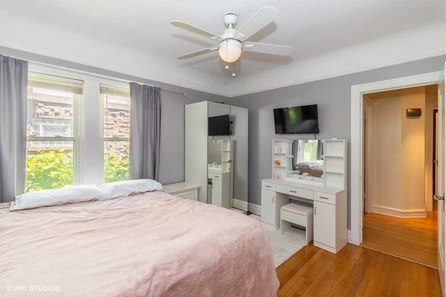 6129 North Mason Avenue Chicago, IL 60646 - Photo 8 of 22 a bedroom with a bed and a flat screen tv