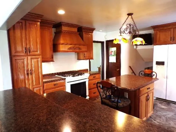 a kitchen with granite countertop a sink and cabinets