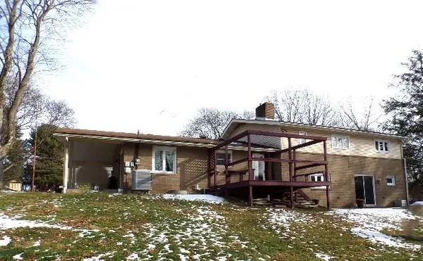 a view of a house with a large window and wooden door