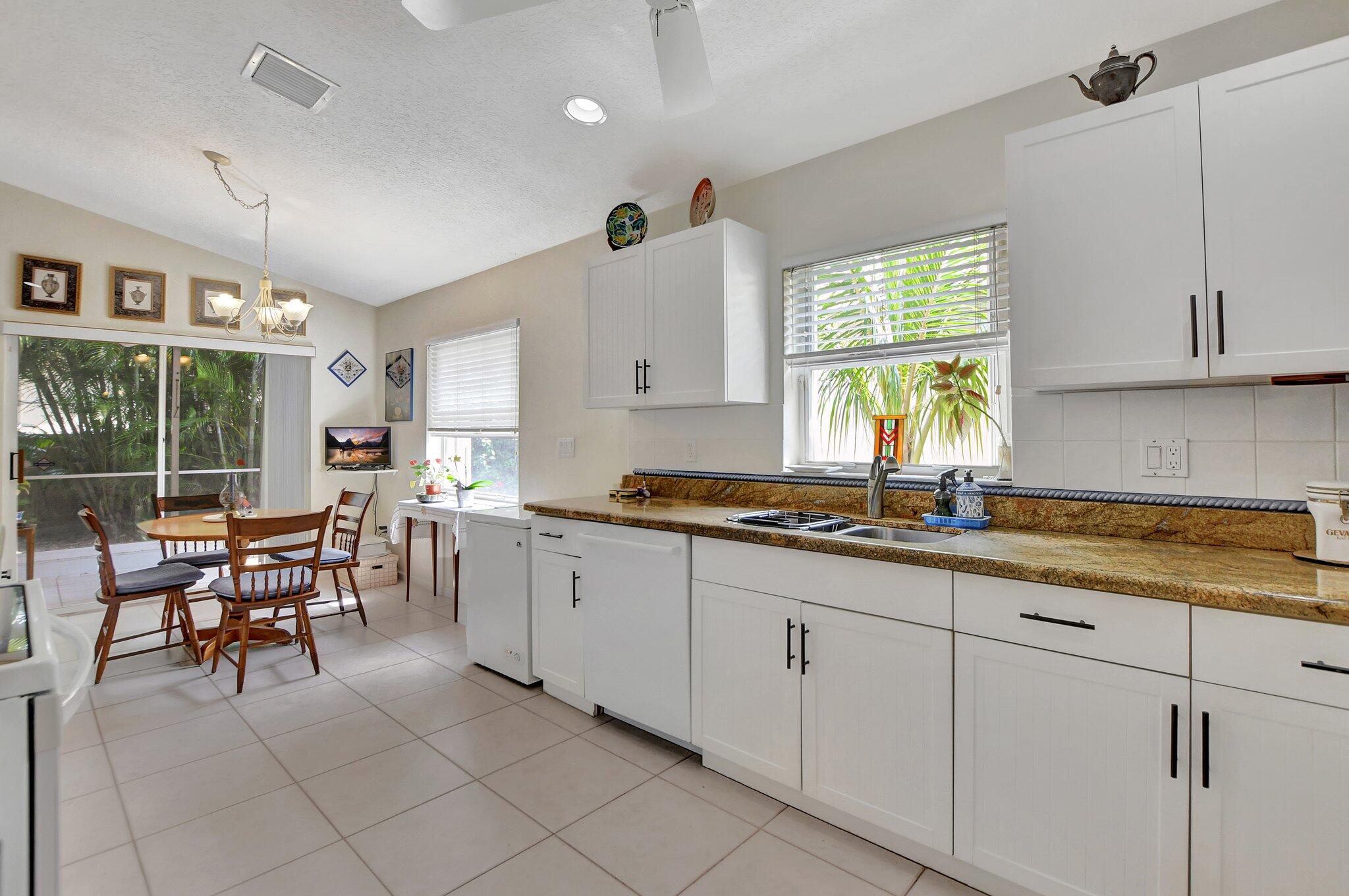8853 Harrods Drive Boca Raton, FL 33433 - Photo 11 of 45 a kitchen with counter space cabinets and appliances