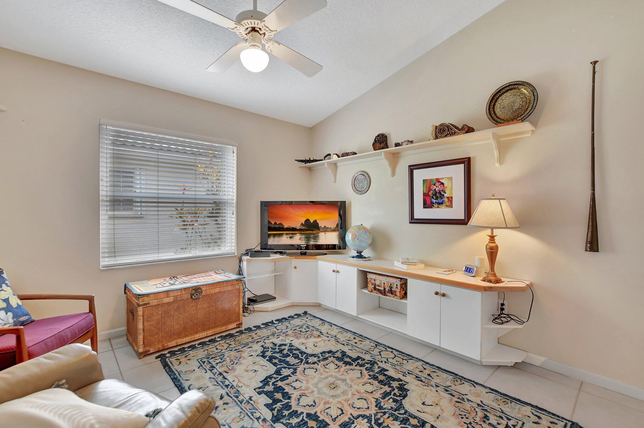 8853 Harrods Drive Boca Raton, FL 33433 - Photo 14 of 45 a living room with furniture and a flat screen tv