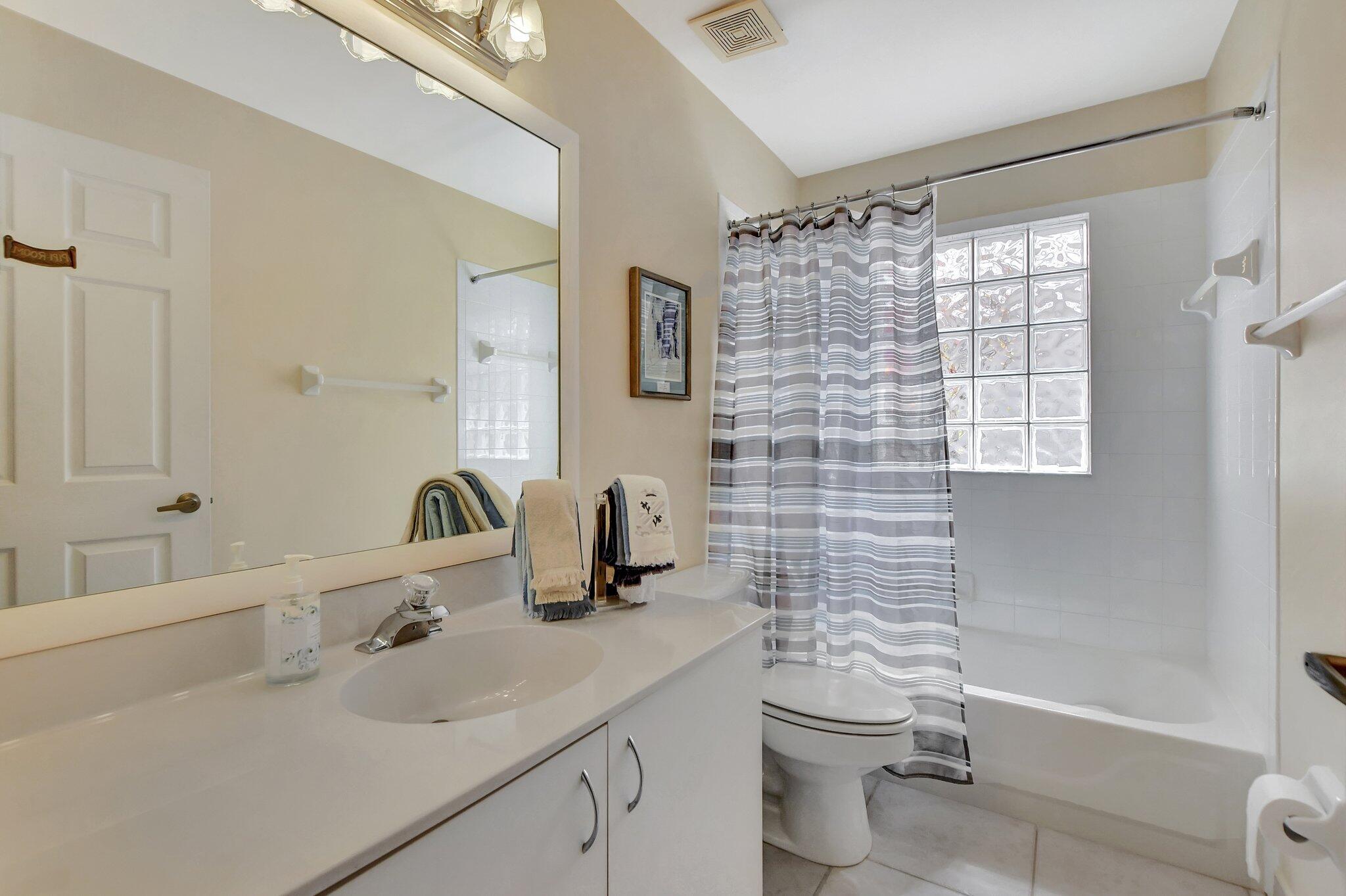 8853 Harrods Drive Boca Raton, FL 33433 - Photo 18 of 45 a bathroom with a sink toilet and shower