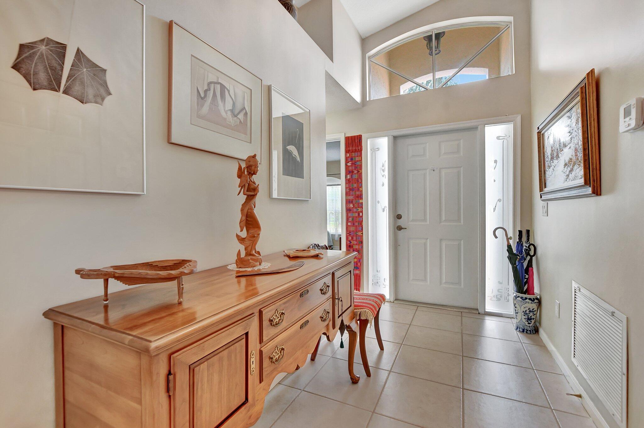 8853 Harrods Drive Boca Raton, FL 33433 - Photo 2 of 45 a hallway with a sink and a mirror