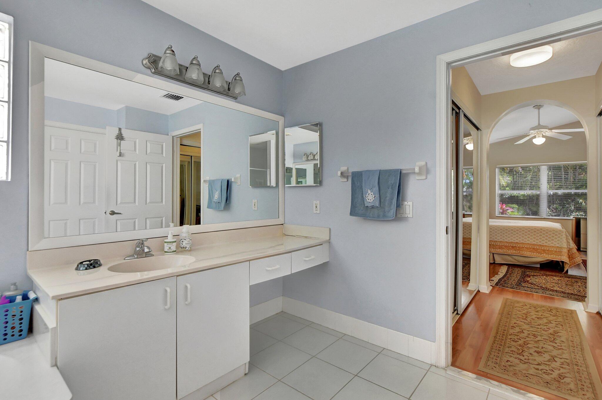 8853 Harrods Drive Boca Raton, FL 33433 - Photo 23 of 45 a spacious bathroom with a sink and a mirror