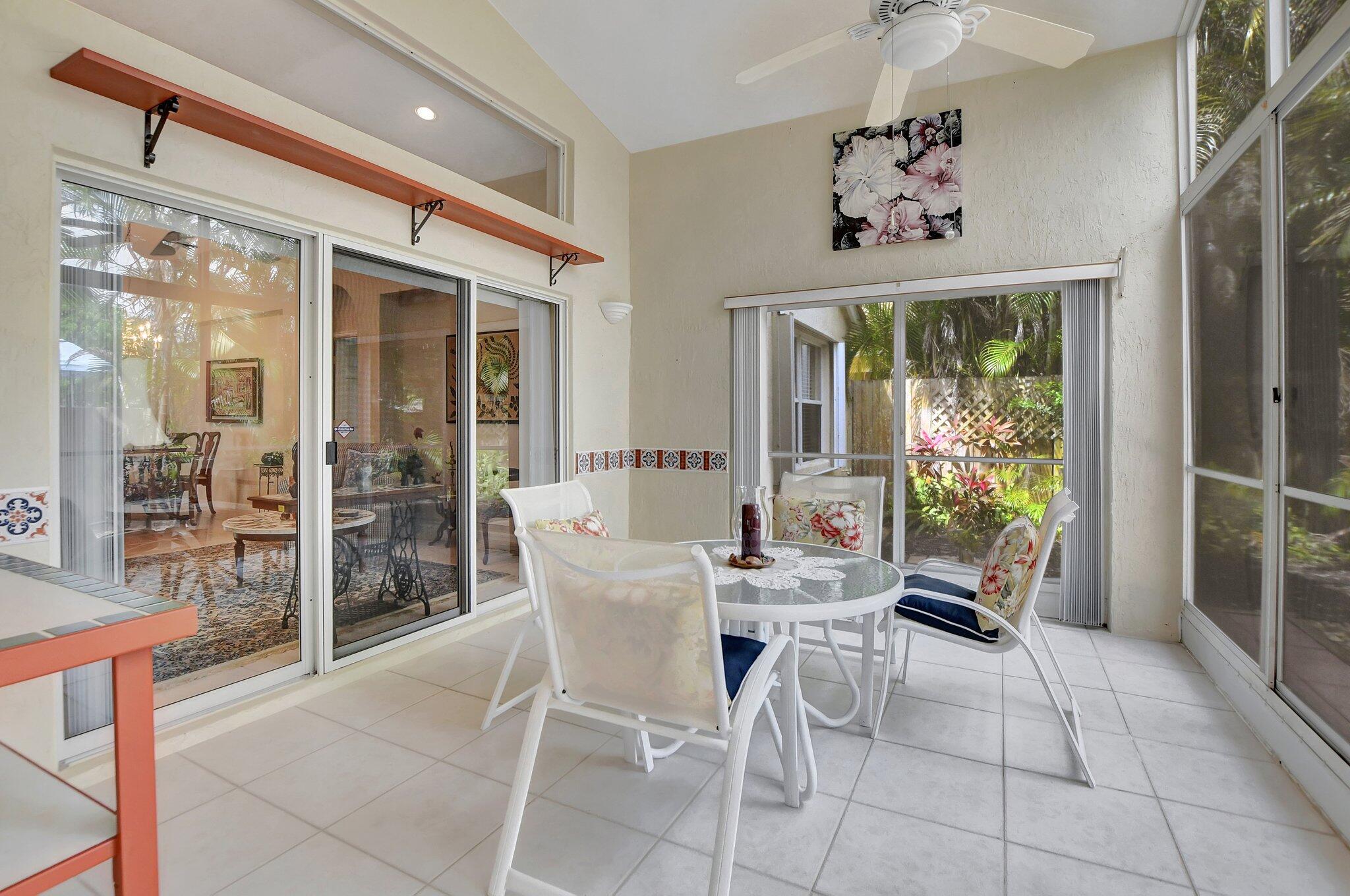 8853 Harrods Drive Boca Raton, FL 33433 - Photo 25 of 45 a view of a dining room with furniture large windows and wooden floor