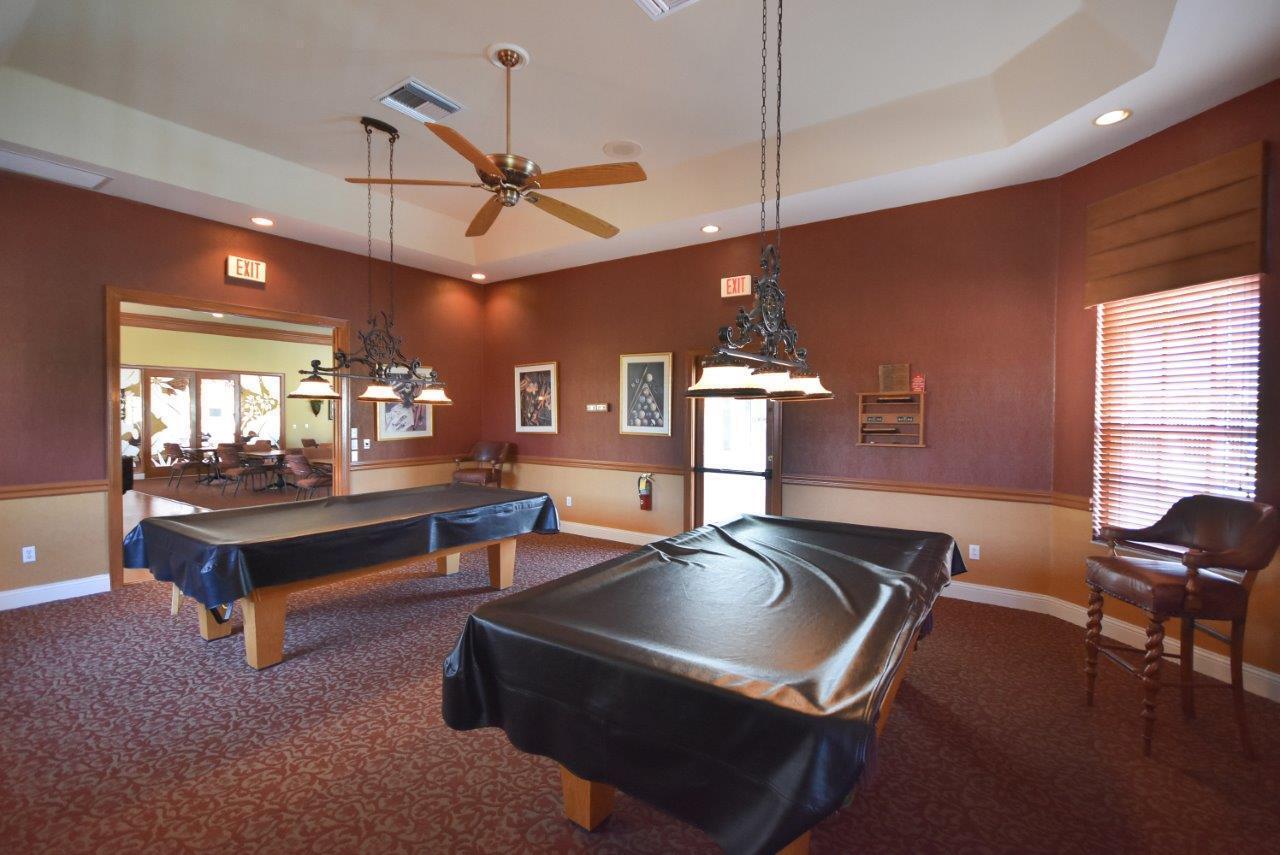 8853 Harrods Drive Boca Raton, FL 33433 - Photo 37 of 45 a room with pool table windows and a chandelier