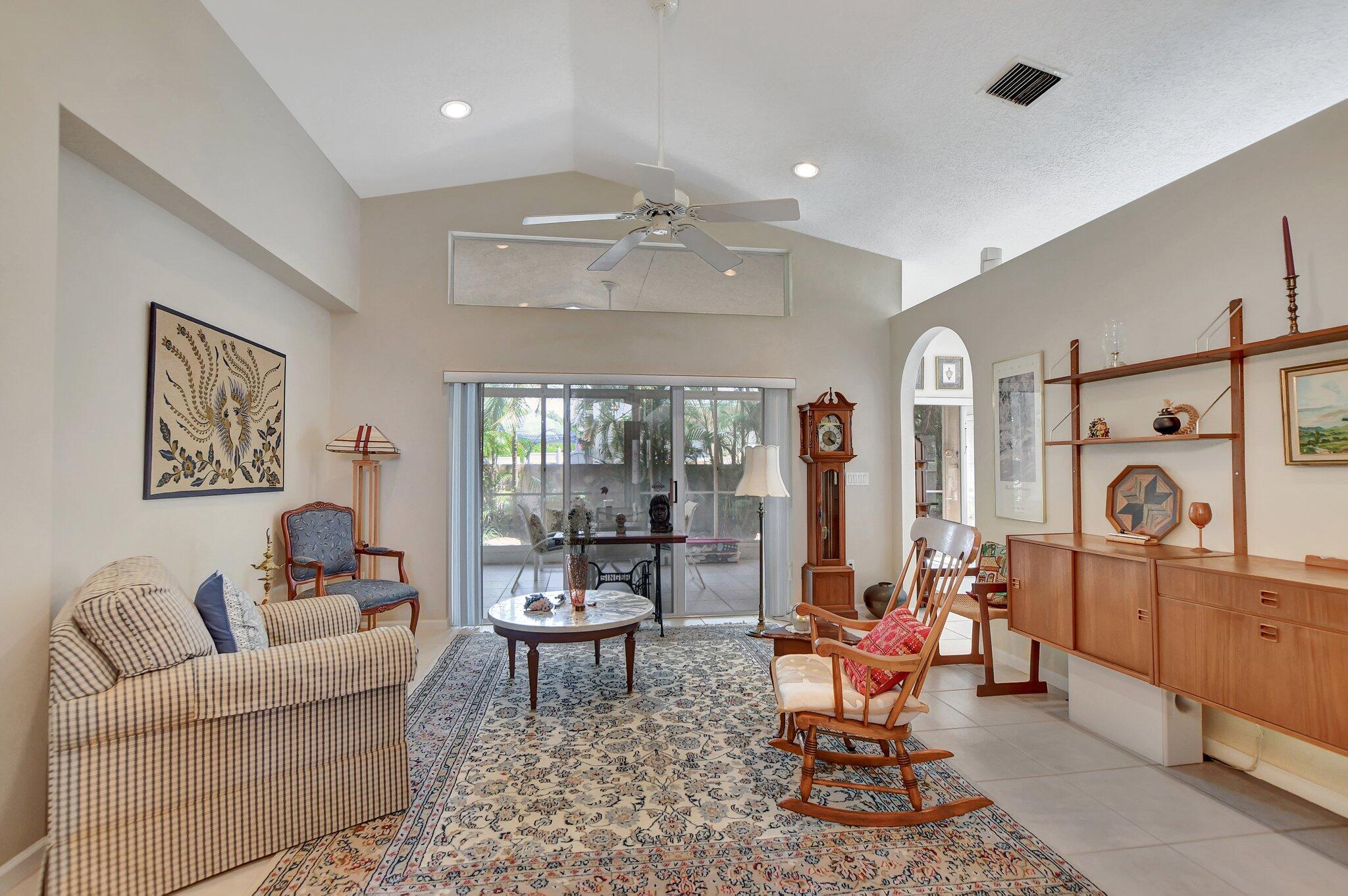 8853 Harrods Drive Boca Raton, FL 33433 - Photo 7 of 45 a living room with furniture a chandelier and a dining table