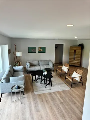 a view of a hallway with living room and furniture