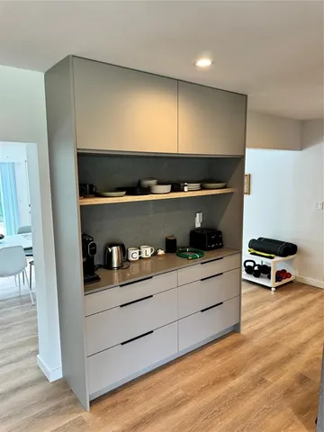a kitchen with kitchen island a stove and a sink